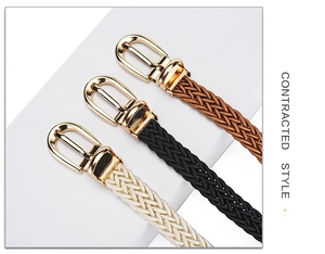 Detail view of woven skinny belts in brown, black, and white with gold pin buckles