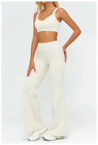 Detail of high-waist flared leggings with contrast stitching on white athletic fabric