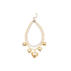 Double-layered pearl heart necklace featuring gold heart pendants on a white background