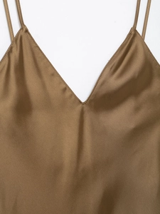 Detailed close-up of V-neck satin slip dress in bronze with smooth texture finish