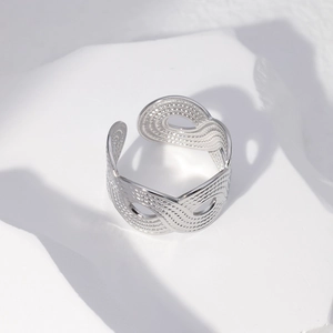 Detailed view of silver stainless steel open ring with fine wavy textured patterns