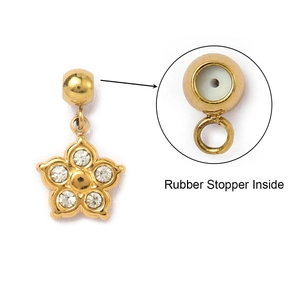 Detail view of gold flower pendant with rhinestones and rubber stopper inside mechanism