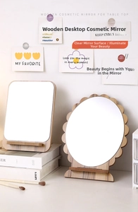 Close-up of wooden makeup mirrors with natural grain frames and minimalist desk stands