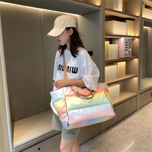 Rainbow gradient quilted fitness bag shown on shoulder in a lifestyle setting