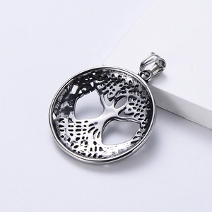 Detail shot of vintage stainless steel Viking Tree of Life round pendant with antique finish