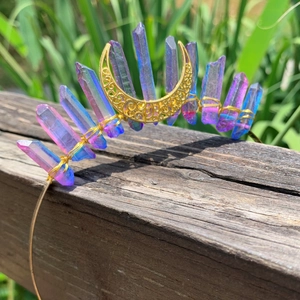 Detail of handmade crown headband with purple crystal clusters and gold moon charm