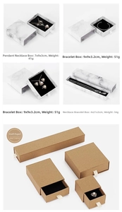 Detailed view of drawer-style jewelry boxes in marble and kraft paper finishes