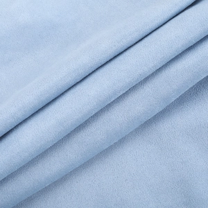 Close-up detail of soft light blue suede fabric texture with high quality fiber finish