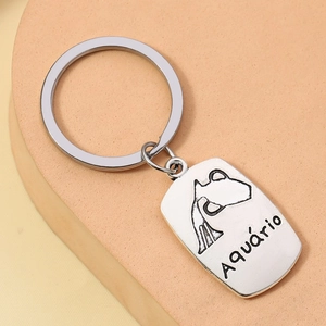 Detail showing an alloy keychain with engraved Aquarius symbol and lettering on a metal tag