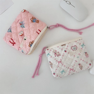 Detail of floral quilted pouches with cute bear prints and durable zipper pulls