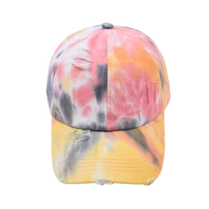 Distressed tie-dye baseball cap in pink and orange tones with street style ripped details