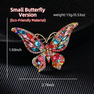 Vintage gold butterfly brooch with colorful crystal rhinestones on a black background