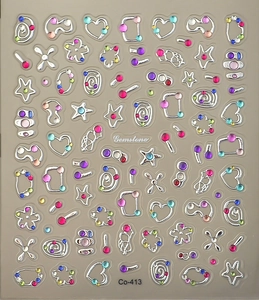 Close-up of holographic silver star and heart nail art stickers with colored rhinestones