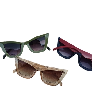 Three trendy cat-eye glasses in green, red-blue, and tea colors with a stylish large frame