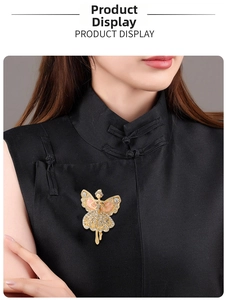 Elegant ballerina brooch with gold plating and white rhinestones on black fabric