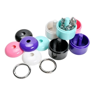 Multiple colors of portable mini plastic jewelry boxes with metal keychains shown in a group