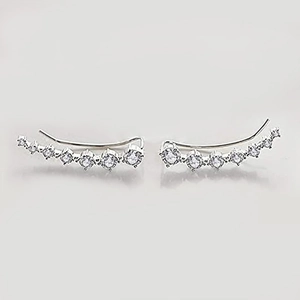 Detailed view of silver curved ear crawler earrings with seven sparkling zircons