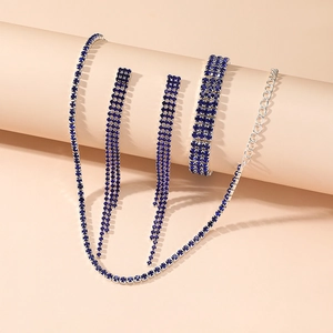 Detail view of a luxury blue rhinestone jewelry set with necklace, earrings, and bracelet