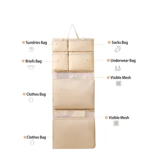 Beige hanging travel organizer with eight functional compartments and mesh pockets