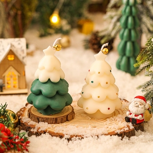 Mini Christmas tree scented candles on snow wood base for festive holiday atmosphere decor