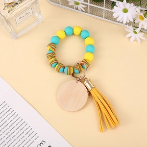 Detail of colorful silicone bead keychain with a blank wooden tag and stylish leather tassel