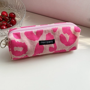 Detailed view of pink leopard print canvas pencil case with merciparis woven label