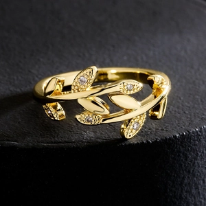 18K gold plated copper leaf open ring with sparkling zircon accents on black background