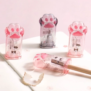 Detail of cute cat paw manual pencil sharpeners on a notebook showing pencil shavings
