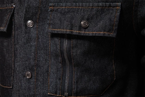 Close-up of denim shirt pockets with metal buttons, zippers and contrast stitching