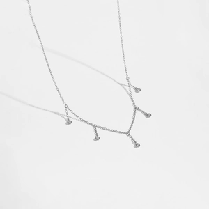 Detailed macro view of S925 silver chain necklace with five clear zircon round pendants