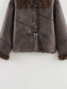 Detail of dark brown faux leather and shearling jacket with metal buckle and collar