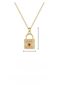Detail of gold heart lock necklace with white zircon pavé and red crystal center