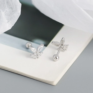 Macro view of crystal butterfly screw back earrings in 925 sterling silver
