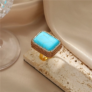 Anello barocco dorato con pietra turchese blu e doppio bordo di strass scintillanti