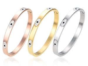 Three-piece evil eye bangles set in rose gold, gold, and silver finishes with zircon stones