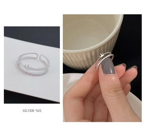Detail of double-layer crown ring in 925 silver with adjustable open band design