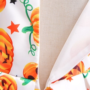 Macro detail of pumpkin and star pattern fabric with hidden zipper on Halloween dress