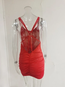 Macro detail of red sequin backless mini dress with ruched fabric and metal ring