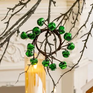 Artificial Christmas wreath featuring glossy green metal bells on a brown twig base