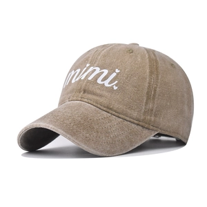 Detail of khaki washed cotton baseball cap with embroidered mimi text and heart pattern