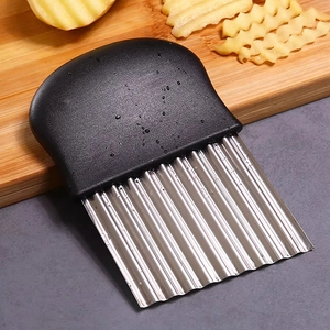 Versatile stainless steel wavy potato slicer with black handle on wooden board