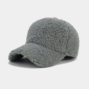 Detailed texture of thick grey lamb wool fabric on a minimalist winter baseball cap
