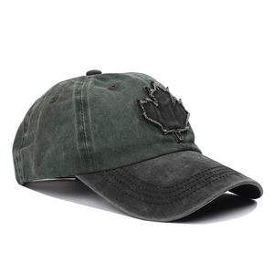 Vintage washed green cotton baseball cap with maple leaf patch and distressed brim
