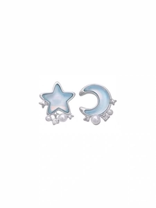 Detailed shot of asymmetric blue star and moon earrings with pearls and zircons