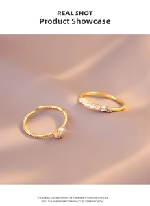 Detailed view of two gold layered rings featuring heart and round cubic zirconia stones