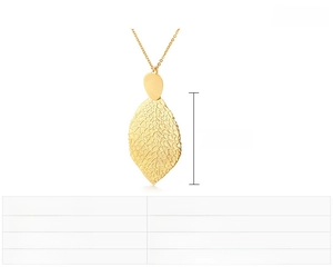 Macro detail of a golden hollow leaf pendant made of stainless steel with 47x31mm dimensions