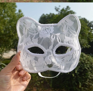 Detail of white lace cat ear mask with heart nose and delicate whiskers for party