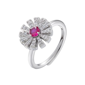 Detailed macro of a silver flower ring with a pink oval gem and sparkling diamonds
