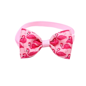 Detail of pink flamingo pattern pet bowtie with adjustable elastic strap and polyester ribbon