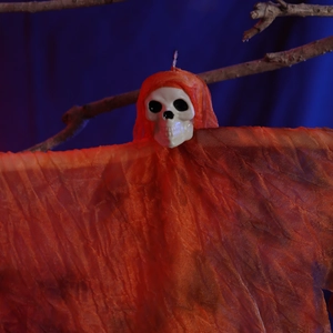 Hanging Halloween skeleton ghost prop with orange gauze fabric on a branch for party decor